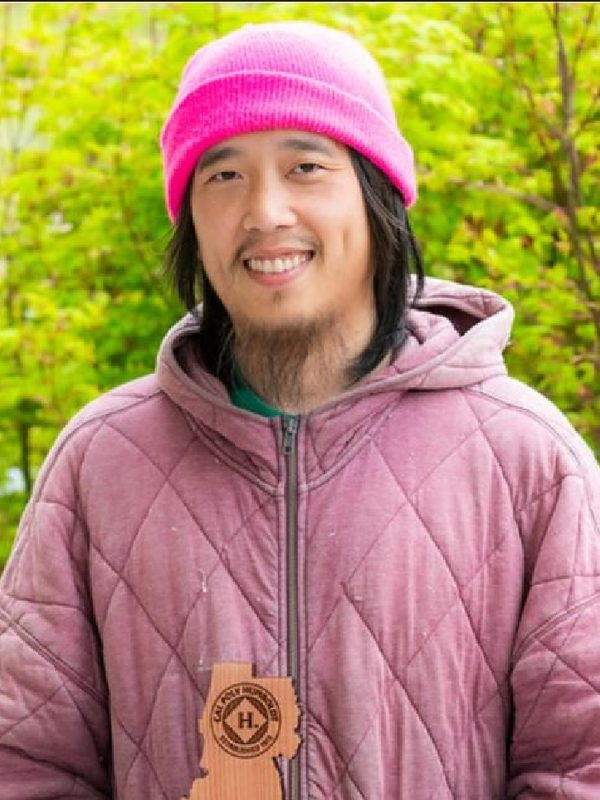 Caleb Chen in a pink beanie, outdoors